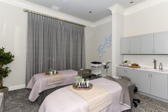 bedroom featuring a sink and crown molding