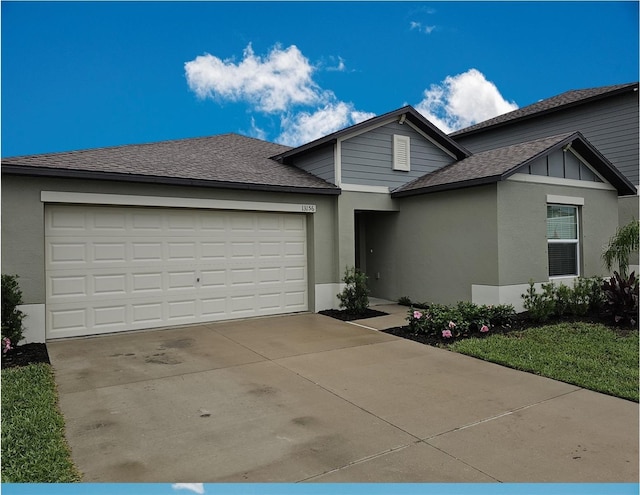 13156 Merlot Sunstone Cv, Parrish, FL 34219 - view of front of house featuring an attached garage, driveway, roof with shingles, and stucco siding