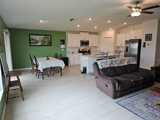 13156 Merlot Sunstone Cv, Parrish, FL 34219 - living room with ceiling fan, recessed lighting, vaulted ceiling, and baseboards