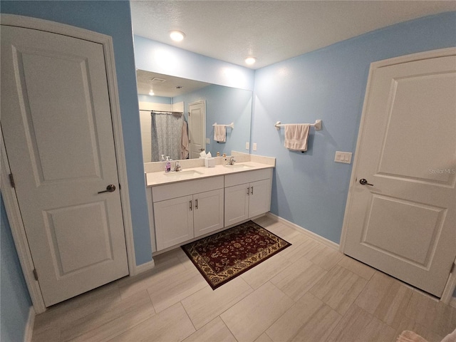 13156 Merlot Sunstone Cv, Parrish, FL 34219 - bathroom featuring double vanity, baseboards, and a shower with curtain
