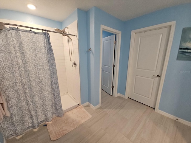 13156 Merlot Sunstone Cv, Parrish, FL 34219 - full bath featuring wood finished floors, baseboards, a tile shower, and recessed lighting