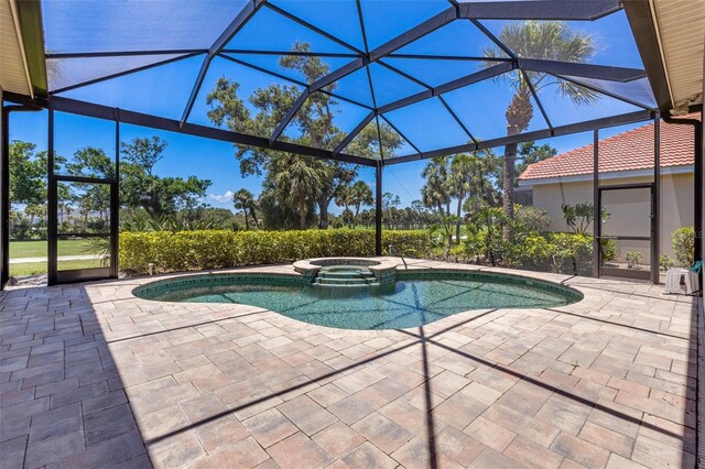 52 Grande Fairway, Englewood, FL 34223 - view of pool featuring a patio area, a pool with connected hot tub, and glass enclosure