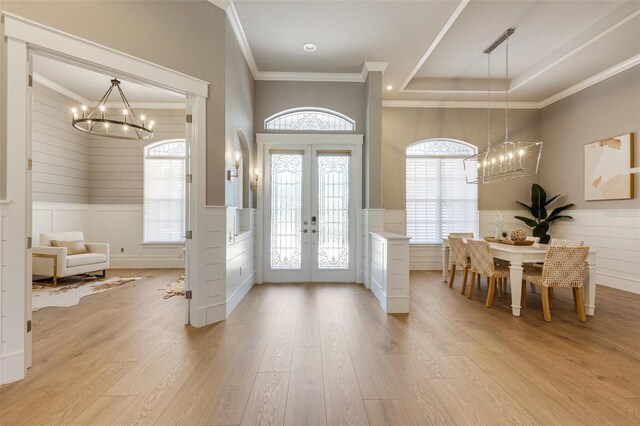 52 Grande Fairway, Englewood, FL 34223 - foyer featuring a chandelier, wainscoting, ornamental molding, french doors, and wood finished floors