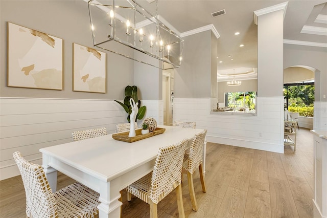 52 Grande Fairway, Englewood, FL 34223 - dining room with arched walkways, wainscoting, light wood-style floors, crown molding, and recessed lighting