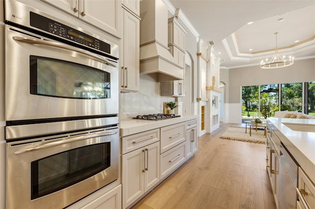52 Grande Fairway, Englewood, FL 34223 - kitchen with appliances with stainless steel finishes, recessed lighting, crown molding, light countertops, and light wood-type flooring