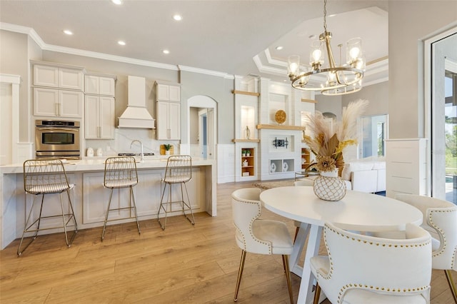 52 Grande Fairway, Englewood, FL 34223 - dining space featuring ornamental molding, a chandelier, recessed lighting, light wood finished floors, and arched walkways