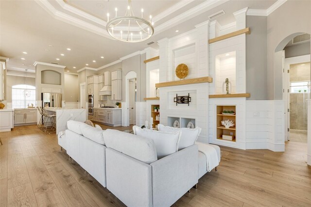 52 Grande Fairway, Englewood, FL 34223 - living room featuring crown molding, light wood-style flooring, healthy amount of natural light, recessed lighting, and arched walkways