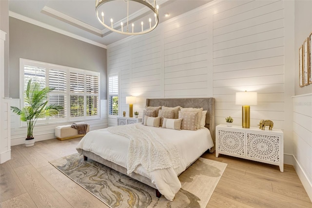 52 Grande Fairway, Englewood, FL 34223 - bedroom with crown molding, a chandelier, a towering ceiling, and light wood-style flooring