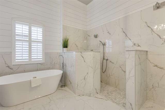 52 Grande Fairway, Englewood, FL 34223 - bathroom featuring marble tiled flooring, a marble finish shower, and a soaking tub