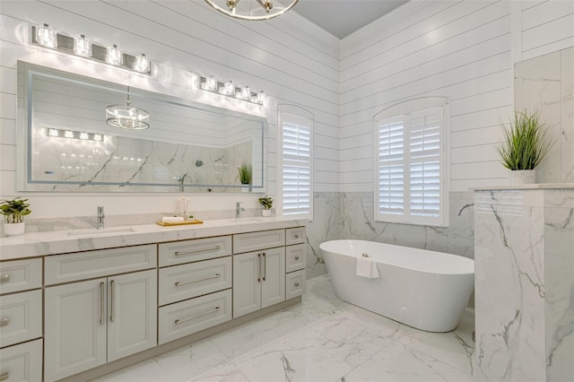 52 Grande Fairway, Englewood, FL 34223 - full bathroom featuring marble finish floors, a chandelier, a freestanding tub, double vanity, and ornamental molding