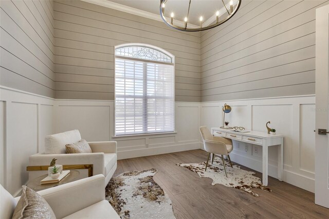 52 Grande Fairway, Englewood, FL 34223 - home office featuring a chandelier, healthy amount of natural light, a decorative wall, wood finished floors, and a wainscoted wall