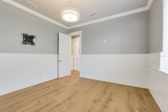 52 Grande Fairway, Englewood, FL 34223 - spare room with ornamental molding, wainscoting, and light wood-style floors