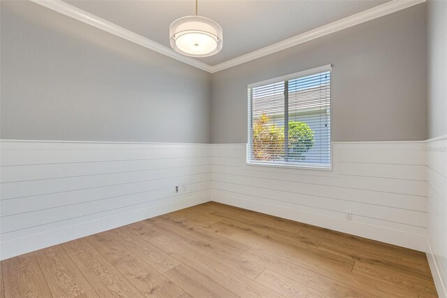52 Grande Fairway, Englewood, FL 34223 - spare room with crown molding, wainscoting, and light wood-style flooring