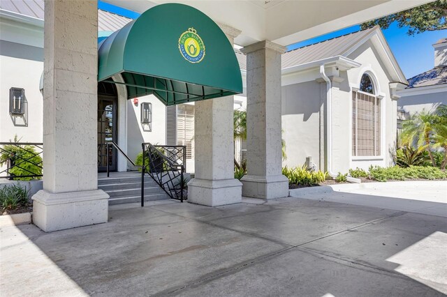 52 Grande Fairway, Englewood, FL 34223 - doorway to property with metal roof, stucco siding, and a standing seam roof