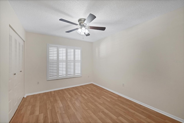 3750 Pinebrook Cir Unit 405, Bradenton, FL 34209 - unfurnished bedroom featuring a closet, light wood-type flooring, baseboards, and a textured ceiling