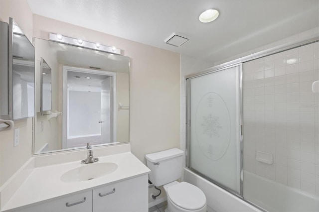 3750 Pinebrook Cir Unit 405, Bradenton, FL 34209 - bathroom with bath / shower combo with glass door, vanity, and toilet