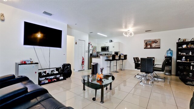 2330 28th Ave E, Palmetto, FL 34221 - living room with light tile patterned floors and a textured ceiling