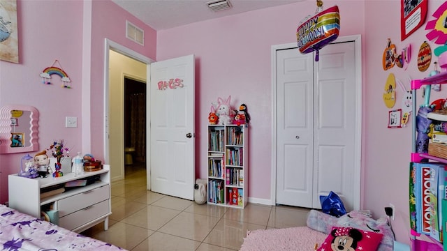 2330 28th Ave E, Palmetto, FL 34221 - bedroom with tile patterned flooring and a closet