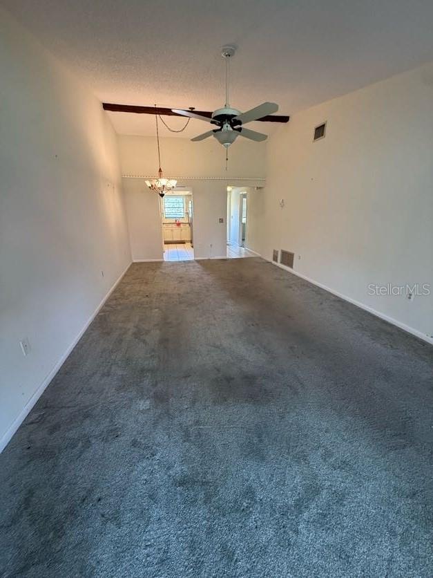 1304 56th St W Unit 1304, Bradenton, FL 34209 - unfurnished living room featuring carpet flooring, ceiling fan, a chandelier, and baseboards