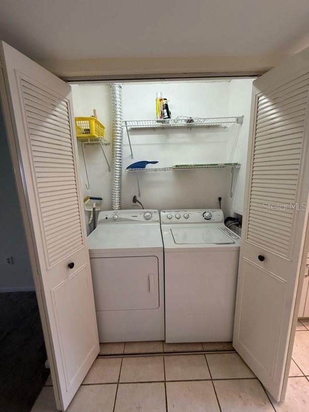 1304 56th St W Unit 1304, Bradenton, FL 34209 - washroom featuring washing machine and dryer and light tile patterned flooring