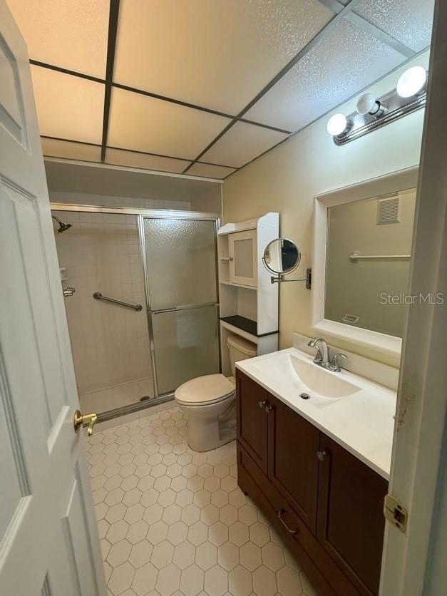 1304 56th St W Unit 1304, Bradenton, FL 34209 - full bath featuring a shower stall, a paneled ceiling, vanity, and toilet