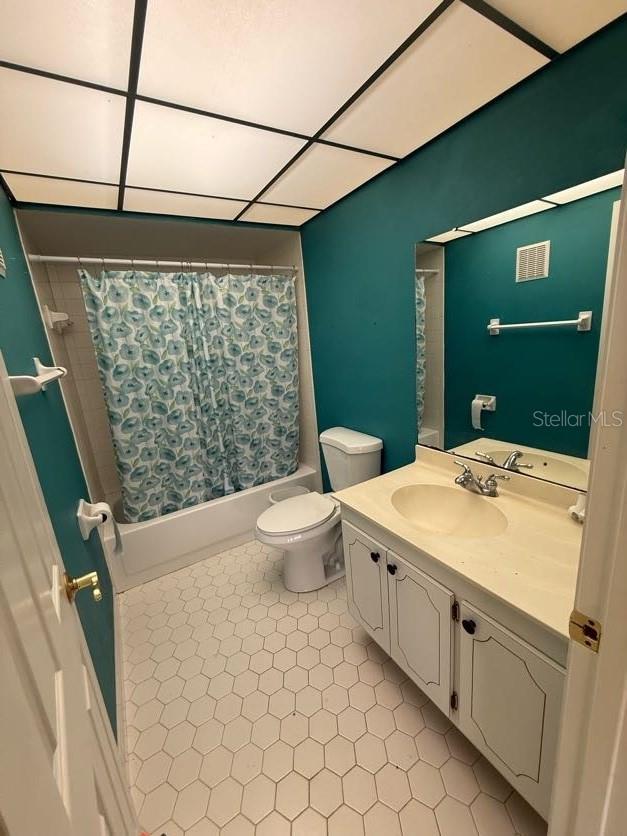 1304 56th St W Unit 1304, Bradenton, FL 34209 - full bathroom with shower / bathtub combination with curtain, toilet, tile patterned flooring, and vanity