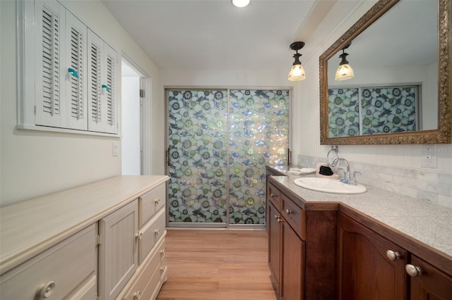 7202 18th Ave NW, Bradenton, FL 34209 - full bathroom featuring vanity, wood finished floors, a shower with curtain, and tasteful backsplash