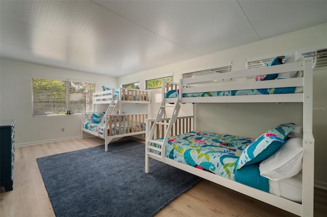 7202 18th Ave NW, Bradenton, FL 34209 - bedroom with multiple windows, wood finished floors, and baseboards