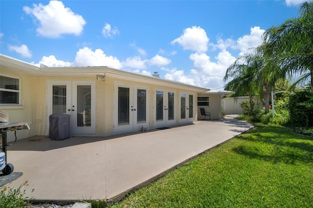 7202 18th Ave NW, Bradenton, FL 34209 - rear view of house with french doors, a patio, and a yard