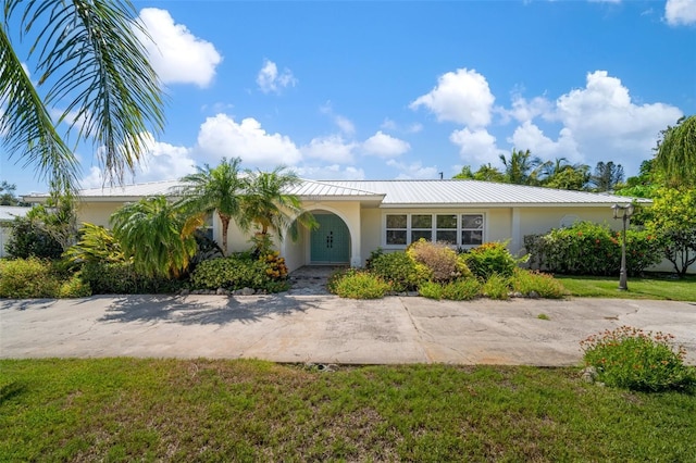7202 18th Ave NW, Bradenton, FL 34209 - ranch-style house with stucco siding, a front yard, and metal roof