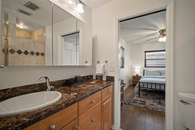 7202 18th Ave NW, Bradenton, FL 34209 - bathroom with wood finished floors, ensuite bath, vanity, toilet, and a ceiling fan