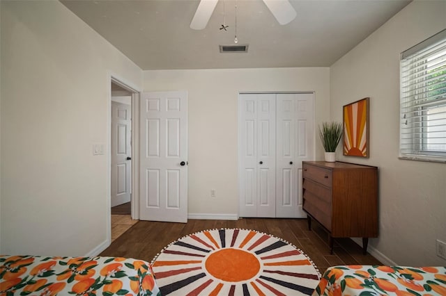 7202 18th Ave NW, Bradenton, FL 34209 - bedroom with dark wood-style floors, a closet, baseboards, and a ceiling fan