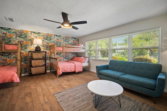 7202 18th Ave NW, Bradenton, FL 34209 - bedroom with hardwood / wood-style floors, baseboards, wallpapered walls, and ceiling fan