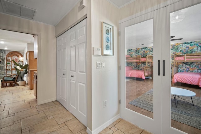 7202 18th Ave NW, Bradenton, FL 34209 - hallway with baseboards, french doors, ornamental molding, and stone finish floors