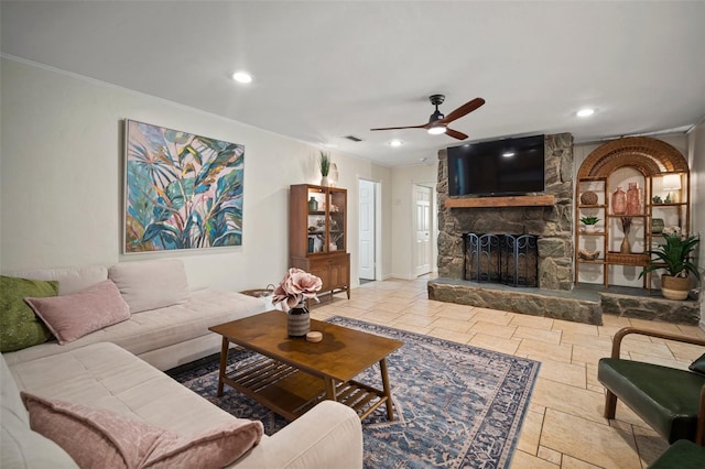7202 18th Ave NW, Bradenton, FL 34209 - living area with a stone fireplace, a ceiling fan, crown molding, recessed lighting, and stone tile floors