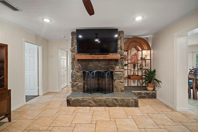 7202 18th Ave NW, Bradenton, FL 34209 - living room featuring a stone fireplace, baseboards, ornamental molding, a ceiling fan, and stone tile flooring