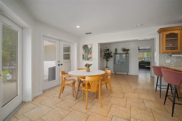 7202 18th Ave NW, Bradenton, FL 34209 - dining area with french doors, light stone finish flooring, and recessed lighting