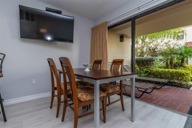 4621 Gulf Of Mexico Dr Unit 2F, Longboat Key, FL 34228 - dining area with light wood-style flooring and baseboards