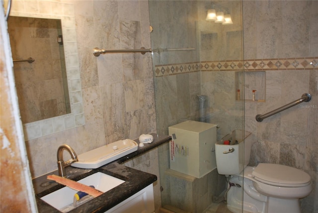 4621 Gulf Of Mexico Dr Unit 2F, Longboat Key, FL 34228 - bathroom with tile walls, toilet, and a sink
