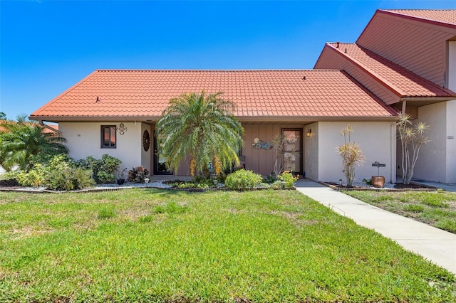 6462 Draw Ln Unit 72, Sarasota, FL 34238 - view of front facade with a front lawn, stucco siding, and a tile roof