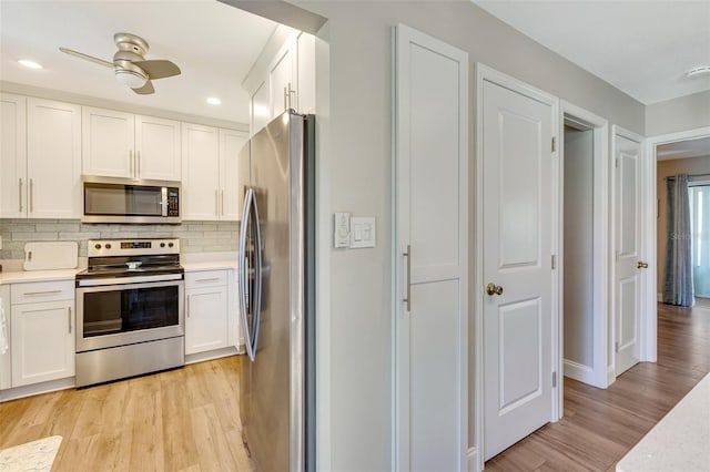 6462 Draw Ln Unit 72, Sarasota, FL 34238 - kitchen with appliances with stainless steel finishes, white cabinets, light wood finished floors, light countertops, and recessed lighting