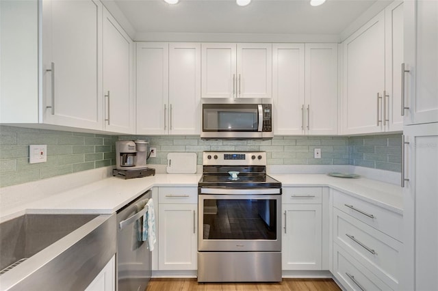 6462 Draw Ln Unit 72, Sarasota, FL 34238 - kitchen featuring appliances with stainless steel finishes, white cabinetry, light countertops, backsplash, and recessed lighting