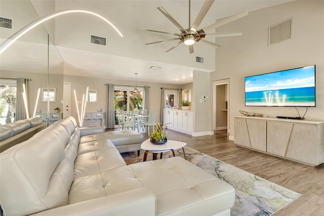 6462 Draw Ln Unit 72, Sarasota, FL 34238 - living area featuring ceiling fan, light wood-style floors, high vaulted ceiling, and baseboards