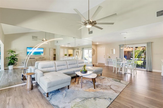 6462 Draw Ln Unit 72, Sarasota, FL 34238 - living room featuring ceiling fan, light wood-style floors, baseboards, a chandelier, and high vaulted ceiling