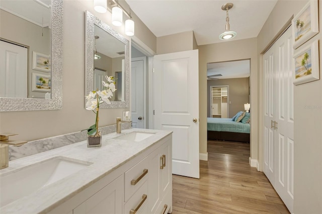 6462 Draw Ln Unit 72, Sarasota, FL 34238 - full bathroom with wood finished floors, connected bathroom, double vanity, and baseboards