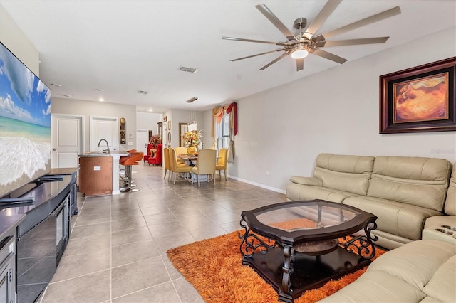 5033 Brickwood Rise Dr, Wimauma, FL 33598 - living room with a ceiling fan, light tile patterned floors, and baseboards
