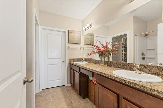 5033 Brickwood Rise Dr, Wimauma, FL 33598 - full bathroom featuring tile patterned floors, double vanity, and a shower