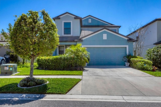 5033 Brickwood Rise Dr, Wimauma, FL 33598 - view of front of property featuring a garage, concrete driveway, stucco siding, and a front lawn