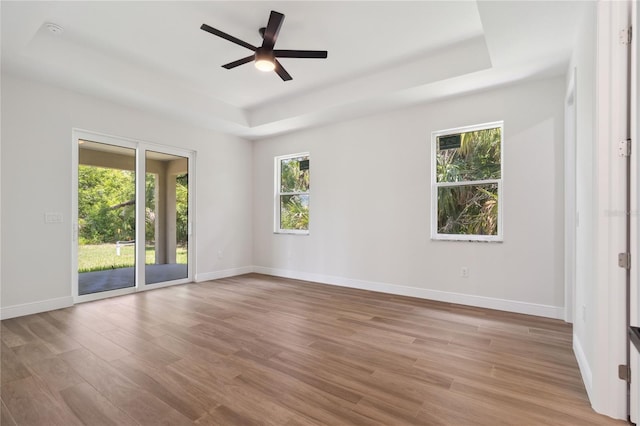 2704 Gaspar Ave, North Port, FL 34288 - unfurnished room with a raised ceiling, wood finished floors, baseboards, and a ceiling fan