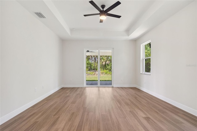 2704 Gaspar Ave, North Port, FL 34288 - spare room with a raised ceiling, light wood finished floors, a ceiling fan, and baseboards